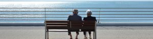 Golden Years Planning Header Image Showing Old Couple on Bench Looking at Ocean